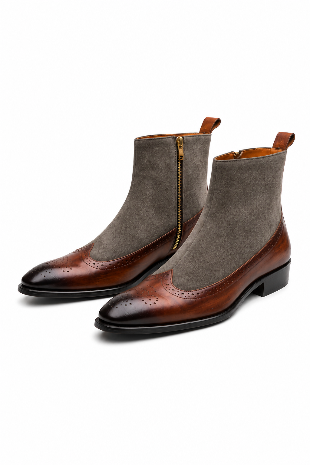 A pair of men's ankle boots featuring a brown leather brogue toe cap and a taupe-brown suede shaft, with a gold zipper on the side.